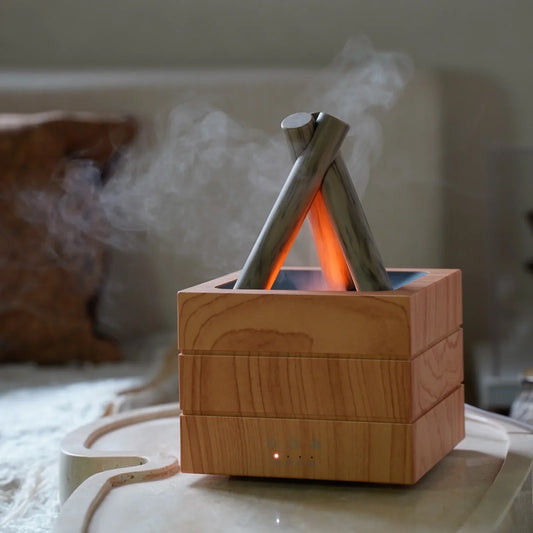 Wooden aroma diffuser with campfire design, emitting mist and warm glow for cozy home ambiance