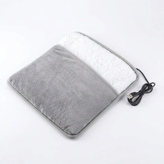 Grey USB heated hand warmer pad with soft plush lining on white background
