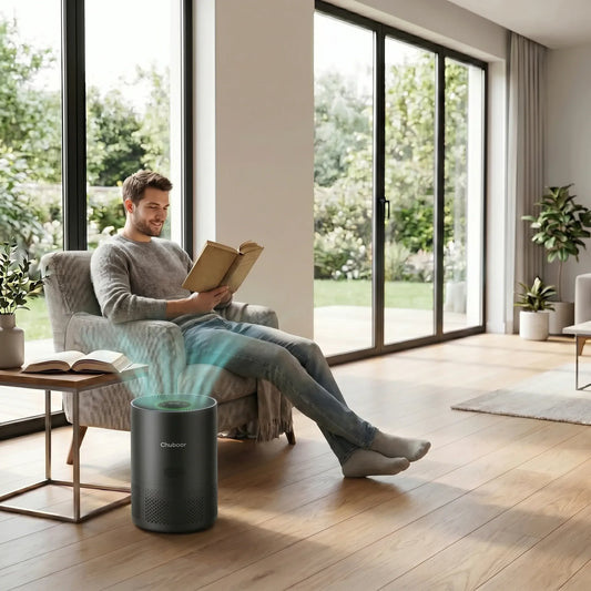 Man reading in modern living room with Chuboor air purifier on wooden floor