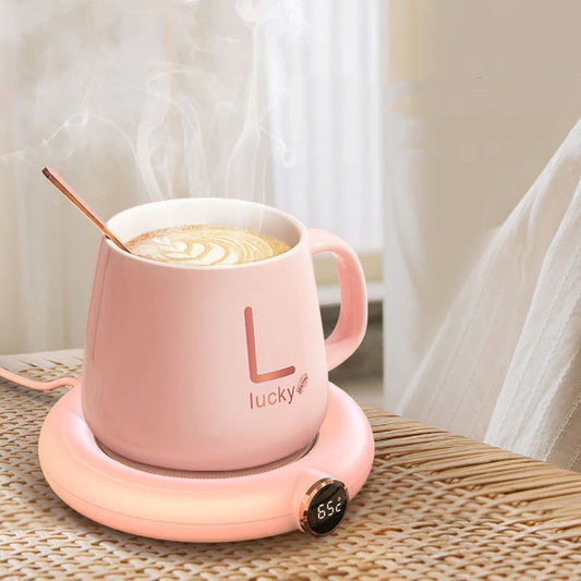 Pink smart mug warmer with digital temp display, heating coffee in cozy home setting