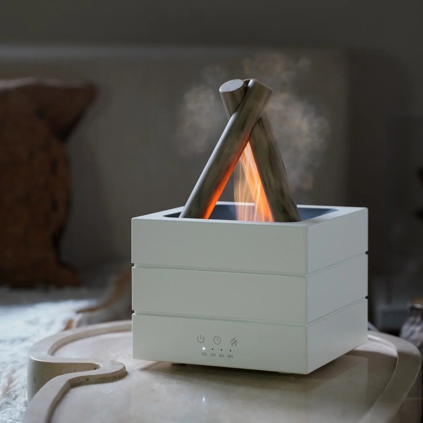 Modern campfire-style humidifier with glowing flame effect and mist, sleek white design for cozy home ambiance