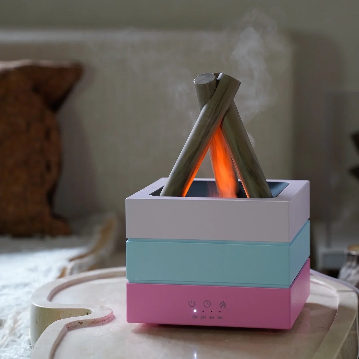 Camping-themed aroma diffuser with glowing fire effect and mist, featuring timer controls and pastel layers