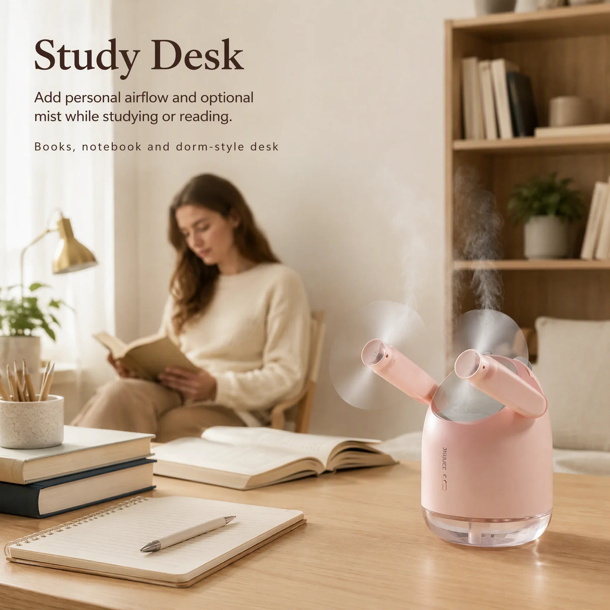 InnoDeviceHub AeroMist 2-in-1 USB Humidifier Fan on a study desk with a person reading nearby.