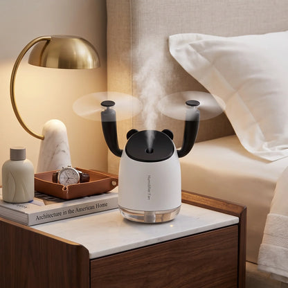 InnoDeviceHub AeroMist 2-in-1 USB Humidifier Fan on a nightstand next to a bed