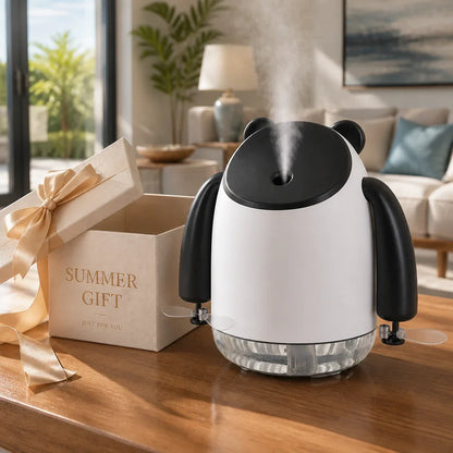 InnoDeviceHub AeroMist panda-shaped humidifier fan misting on a wooden table next to a gift box.
