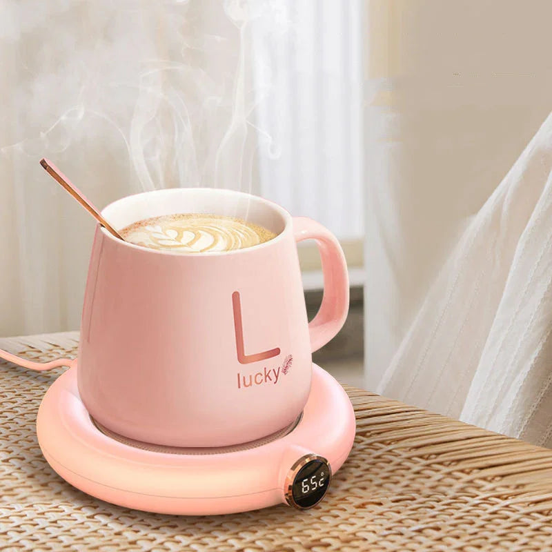 Pink smart mug warmer with digital temp display, heating coffee in cozy home setting